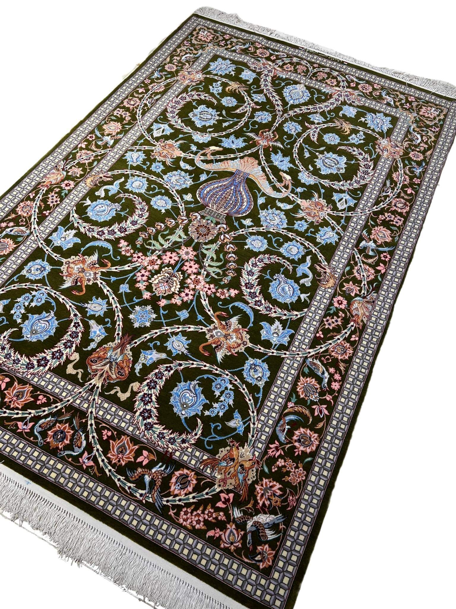 Elegant Isfahan rug featuring blue and pink flower motifs.